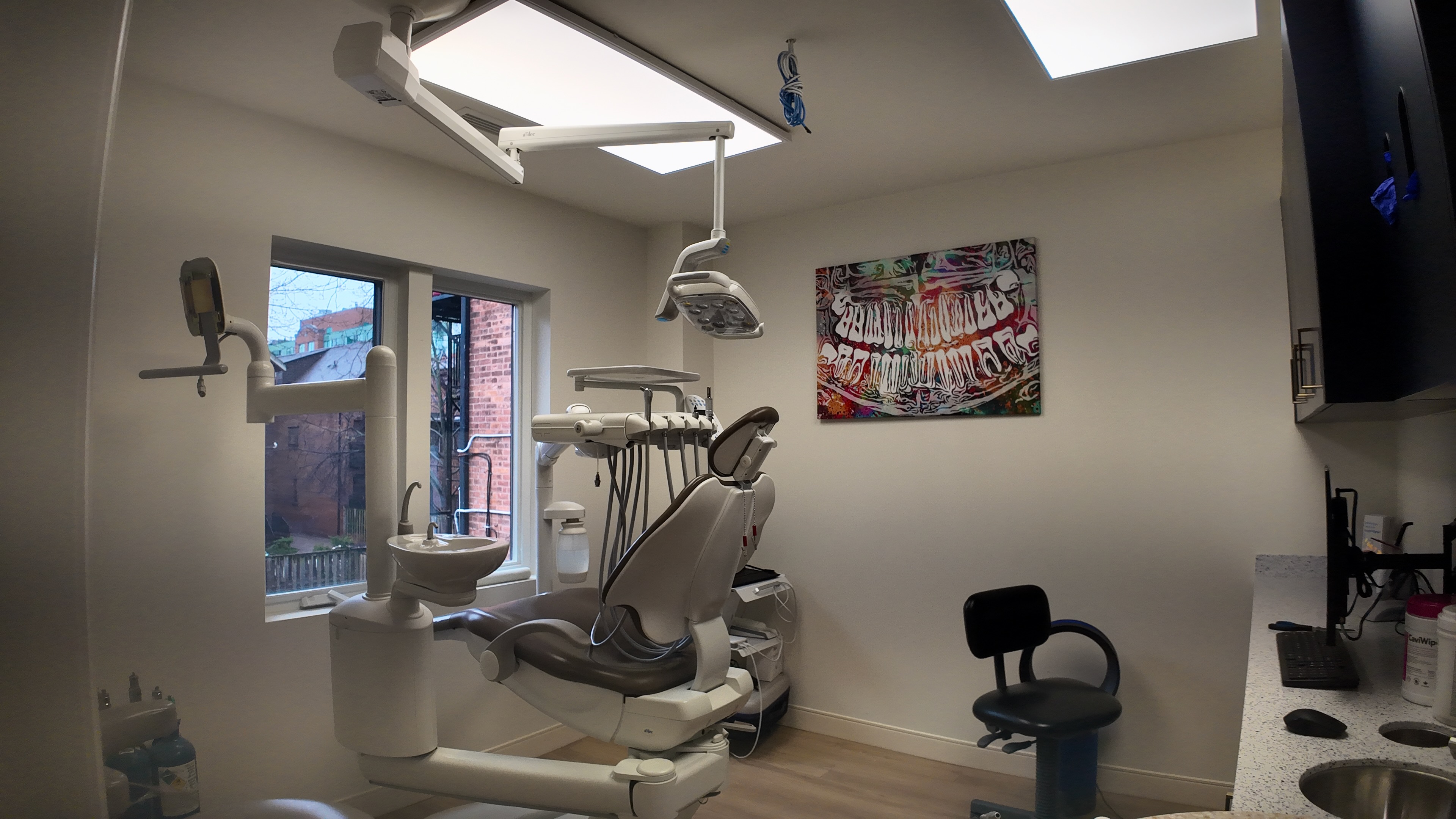 Treatment room at Madison Ave Dental Group with patient chair and overhead light.
