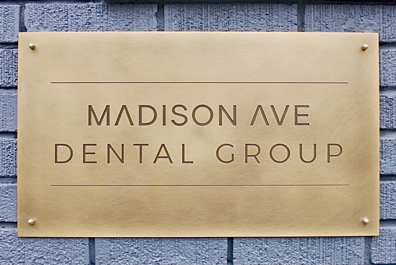 Exterior Madison Ave Dental Group sign.