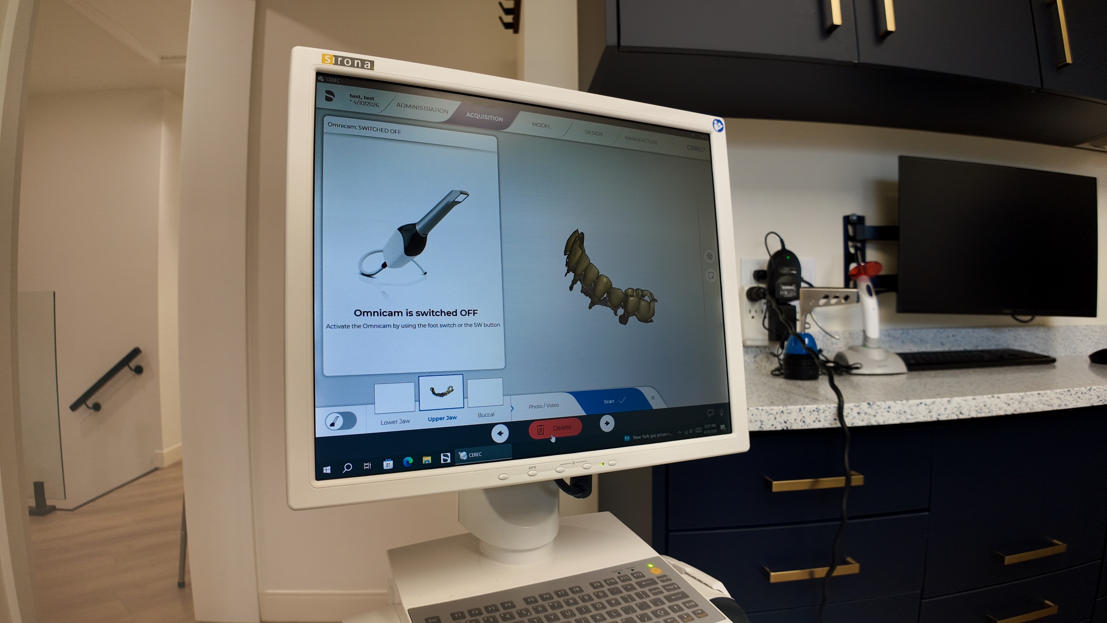 Chairside monitor and digital workflow station inside a treatment room.